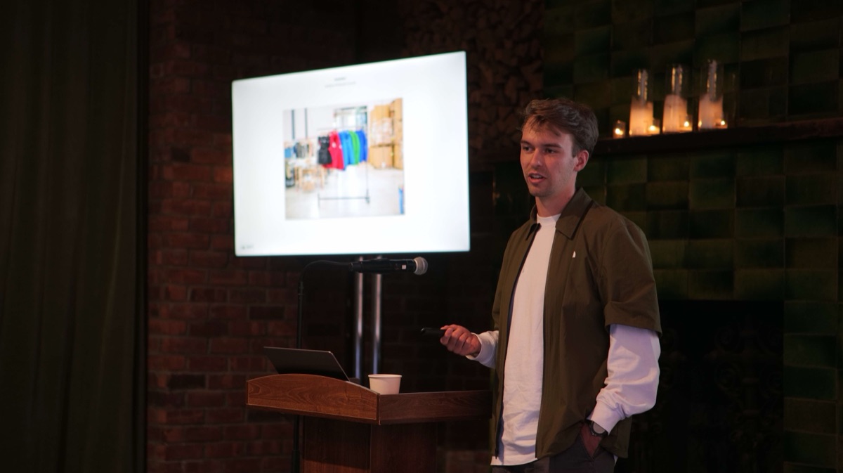 A speaker presenting alongside a product slide