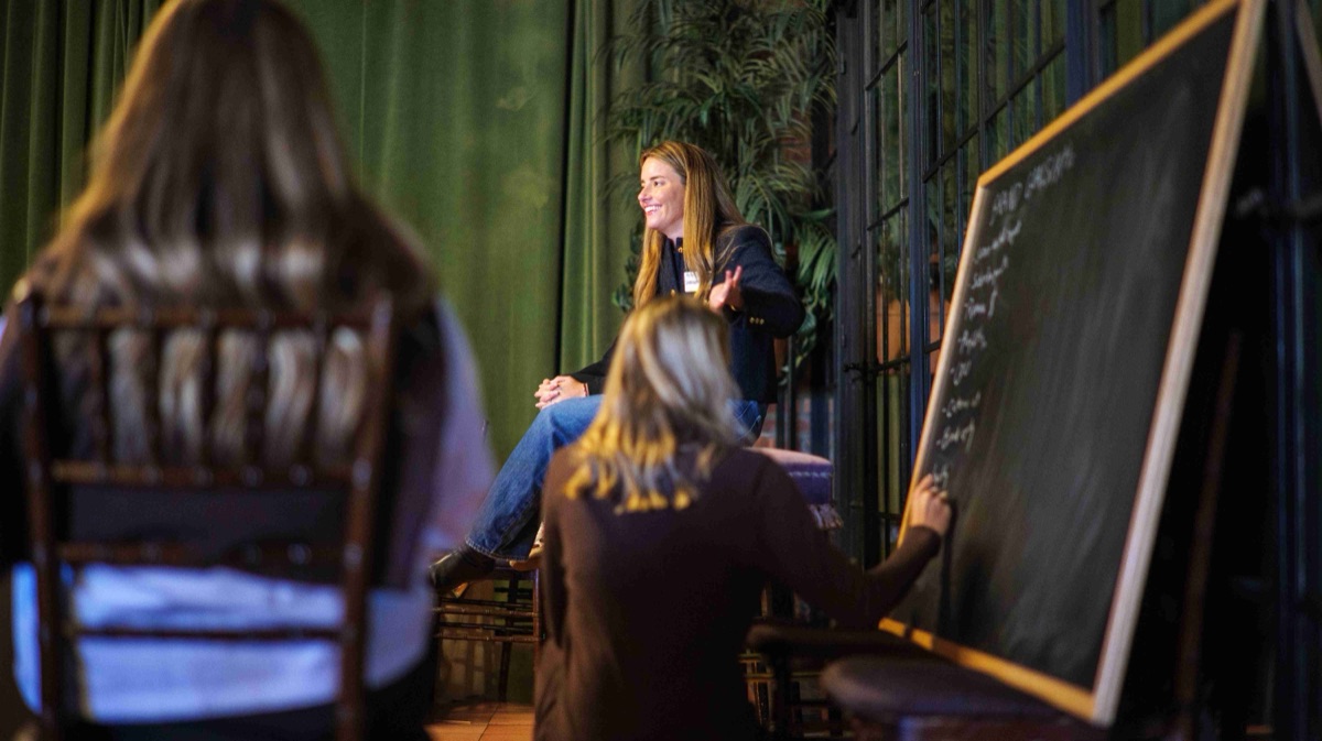 A breakout session gathered around a chalkboard