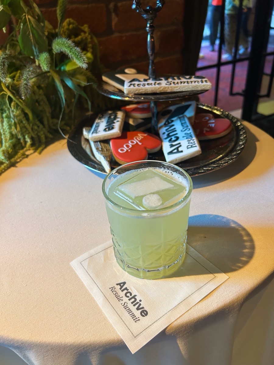 A cocktail served beside branded cookies